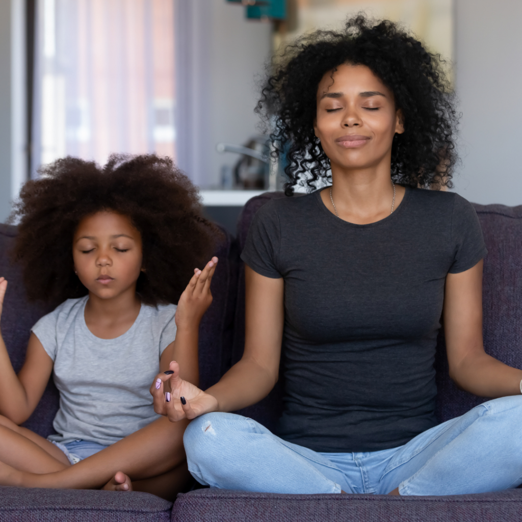 repair your brain with mindfulness; mother and daughter meditating on couch. 